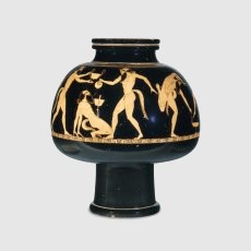 A troupe of satyrs: This mushroom-shaped vessel would have been filled with wine and set to float in a large krater filled with ice-cold water. When the wine was cool enough it would have been removed and mixed with water before being drunk. Satyrs were the followers of the wine-god Dionysos, and thus an appropriate subject for a wine-cooler. The ones shown here are performing various acrobatic feats involving wine cups. One wears the costume and carries the wand of the messenger god Hermes, and it has been suggested that the troupe may evoke the chorus of a satyr play, with Hermes as the leader. Like his contemporary the Brygos Painter, Douris was a prolific cup painter of the early decades of the fifth century BC. Characteristic of his personal style are the curved W' lines marking the satyrs' hips, and the small arc at the junction of the lines marking the lower boundary of the pectoral muscles.